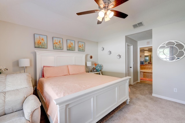 bedroom featuring light carpet, ensuite bathroom, and ceiling fan