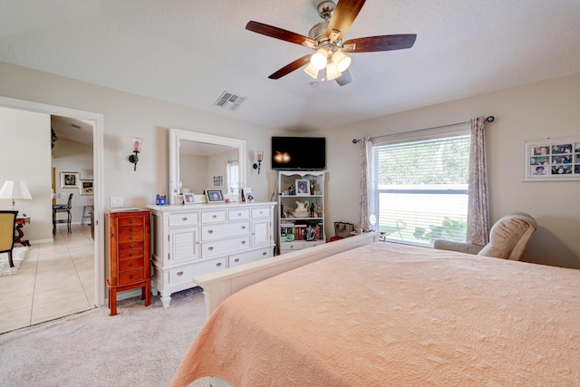 carpeted bedroom featuring ceiling fan and lofted ceiling