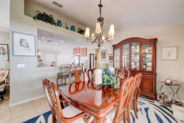 dining area featuring light tile patterned floors and a notable chandelier