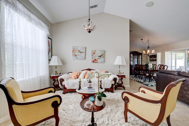 living room with light tile patterned flooring, a chandelier, and lofted ceiling