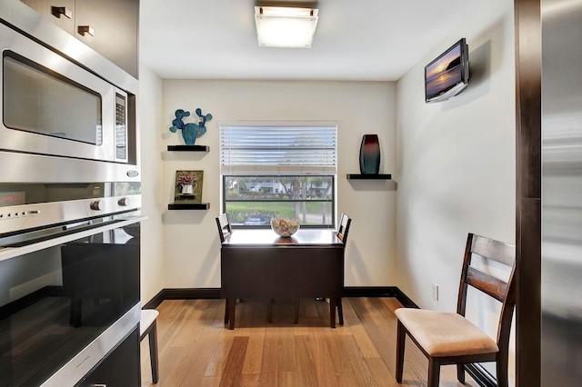 dining space with light wood-type flooring