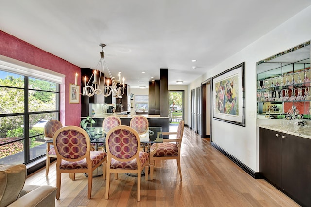 dining room featuring light hardwood / wood-style flooring and an inviting chandelier