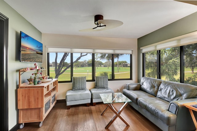 sunroom / solarium featuring ceiling fan