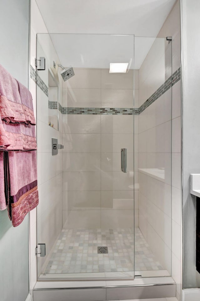 bathroom with a shower with door