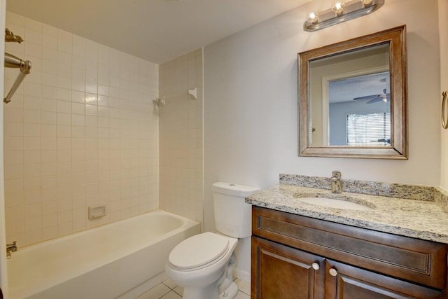 full bathroom featuring ceiling fan, tile patterned floors, toilet, vanity, and tiled shower / bath