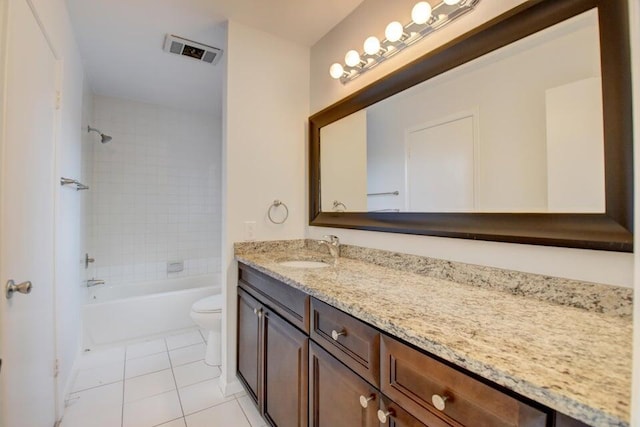 full bathroom featuring tile patterned floors, vanity, toilet, and tiled shower / bath combo