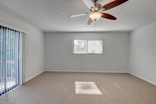 spare room with carpet flooring, ceiling fan, and a textured ceiling