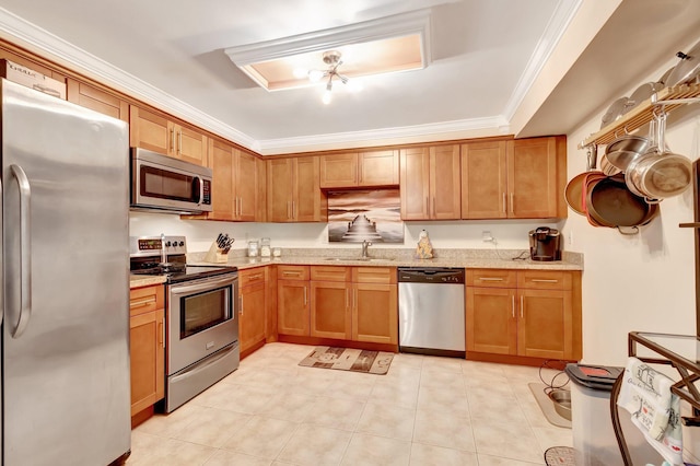 kitchen featuring light stone counters, sink, crown molding, and appliances with stainless steel finishes