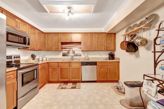 kitchen with sink, light stone countertops, ornamental molding, light tile patterned floors, and stainless steel appliances