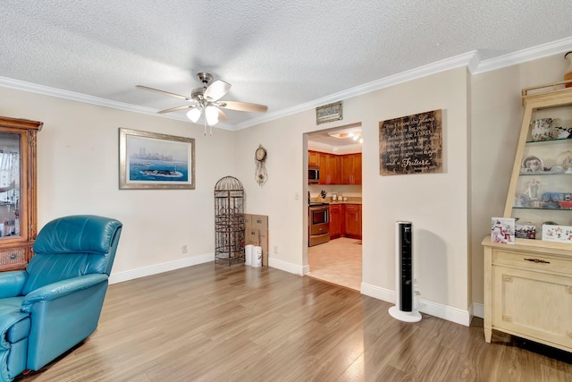 living area with crown molding, ceiling fan, a textured ceiling, and light wood-type flooring