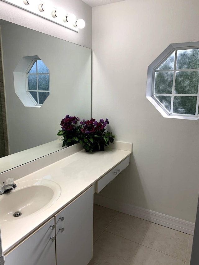 bathroom featuring vanity, baseboards, and tile patterned floors