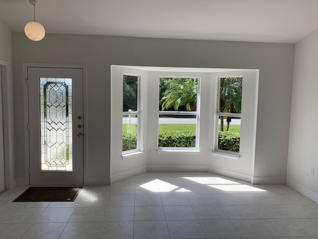 entryway featuring tile patterned flooring and baseboards