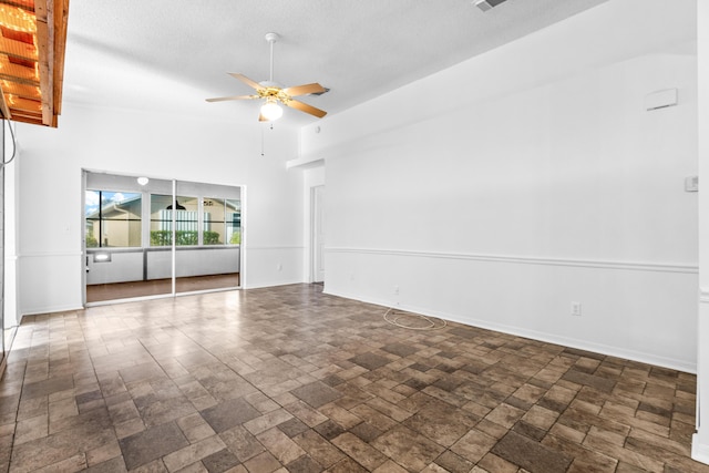 spare room with ceiling fan, high vaulted ceiling, and a textured ceiling