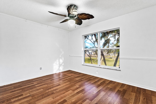 spare room with a textured ceiling, ceiling fan, and dark hardwood / wood-style floors