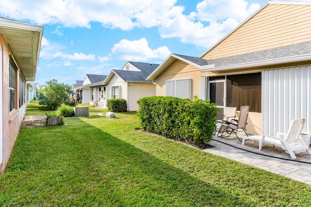 view of yard featuring a residential view and a patio