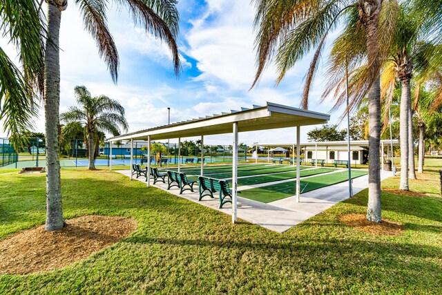 view of tennis court with basketball hoop