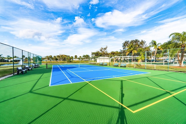 view of tennis court featuring fence