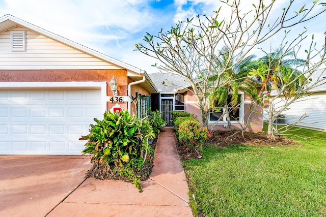 view of front of home featuring a garage and a front lawn