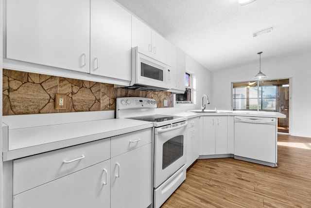 kitchen featuring pendant lighting, white cabinetry, white appliances, and sink