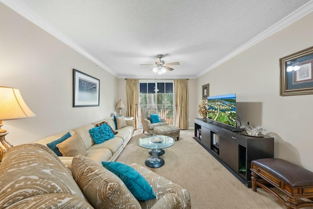 living room featuring ceiling fan, carpet floors, a textured ceiling, and ornamental molding