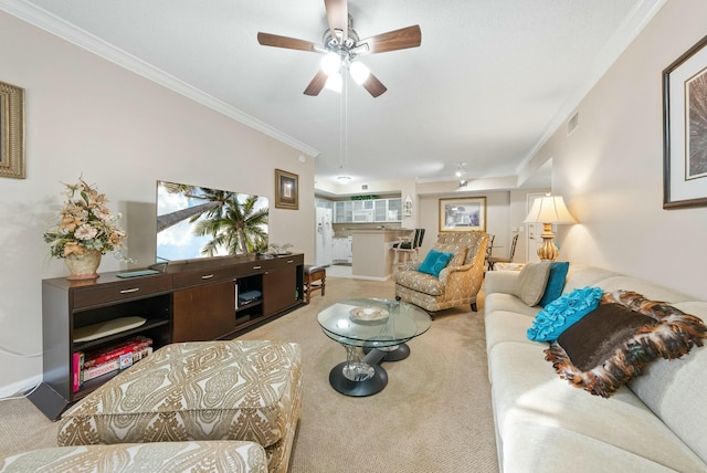 carpeted living room with crown molding, ceiling fan, and a healthy amount of sunlight