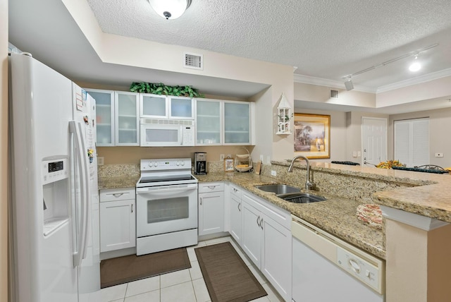 kitchen featuring kitchen peninsula, a textured ceiling, white appliances, sink, and white cabinets