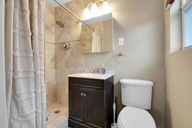 bathroom with curtained shower, vanity, and toilet