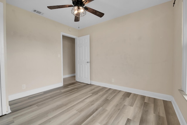 empty room with ceiling fan and light hardwood / wood-style flooring