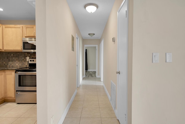 hallway featuring light tile patterned flooring