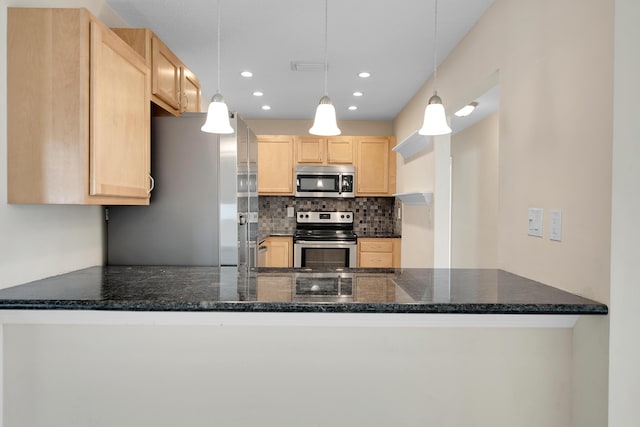 kitchen with kitchen peninsula, light brown cabinetry, backsplash, stainless steel appliances, and hanging light fixtures