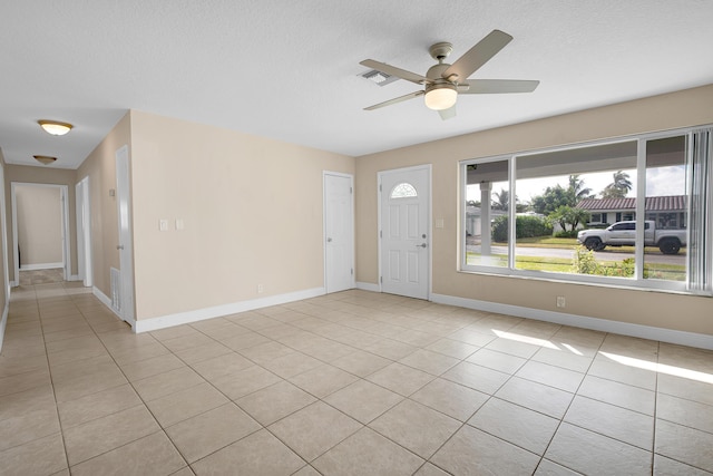 foyer featuring ceiling fan and light tile patterned flooring