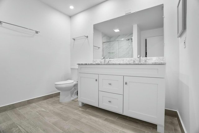 bathroom with vanity, toilet, and an enclosed shower