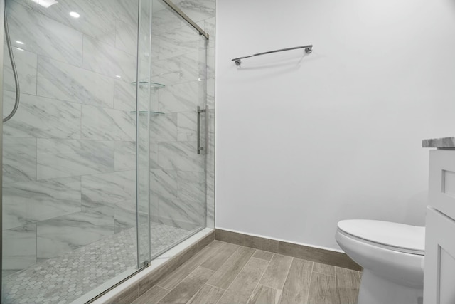 bathroom with an enclosed shower and toilet