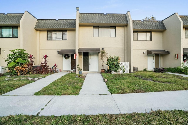 view of property with a front yard and central air condition unit