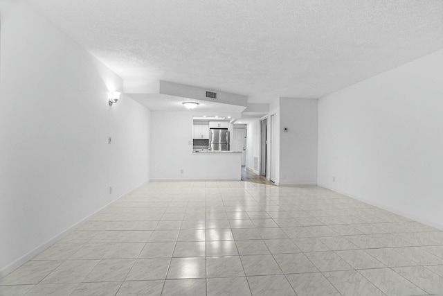 unfurnished living room featuring a textured ceiling