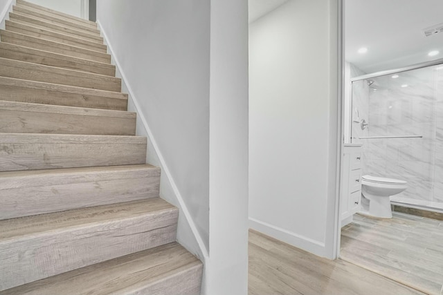 stairs with wood-type flooring