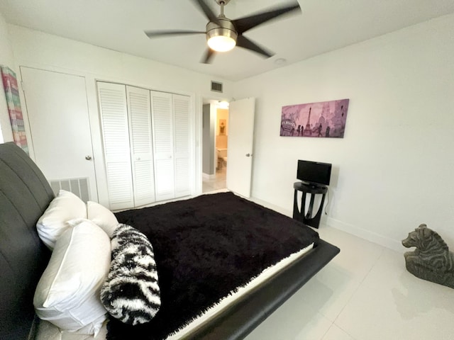 bedroom featuring ceiling fan, a closet, and light tile patterned floors