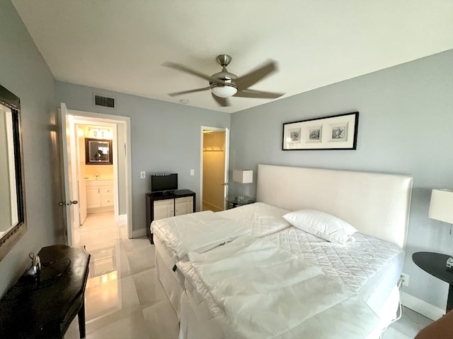 tiled bedroom with connected bathroom and ceiling fan