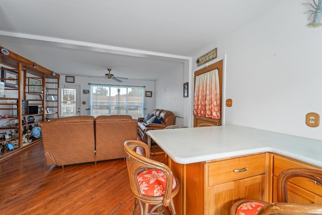 kitchen with ceiling fan, kitchen peninsula, and hardwood / wood-style floors