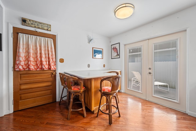 bar featuring french doors and hardwood / wood-style flooring