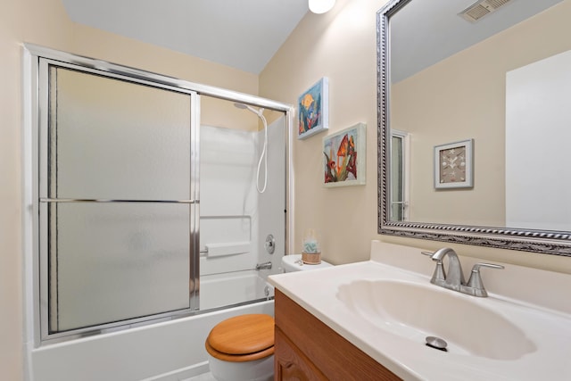 full bathroom featuring vanity, shower / bath combination with glass door, and toilet