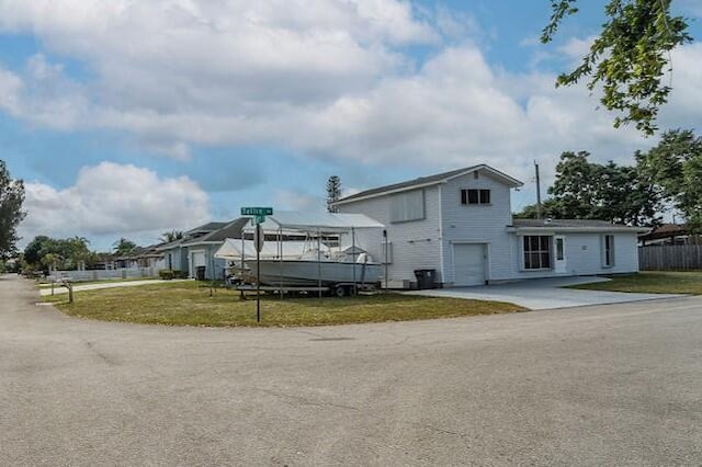 view of front of house with a garage and a front yard