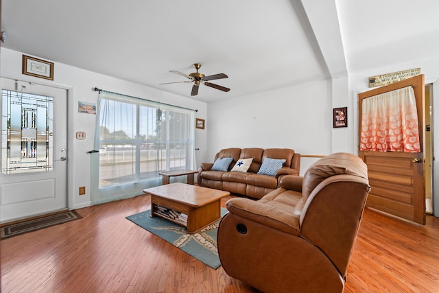 living room featuring ceiling fan and light hardwood / wood-style floors