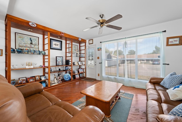 living room featuring hardwood / wood-style floors and ceiling fan