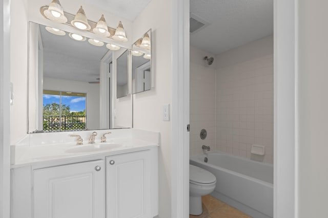 full bathroom with tile patterned flooring, a textured ceiling, tiled shower / bath combo, and toilet