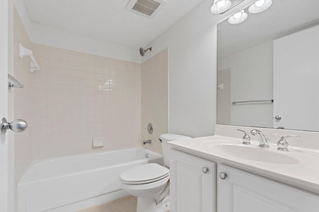 full bathroom with tub / shower combination, tile patterned floors, a textured ceiling, toilet, and vanity