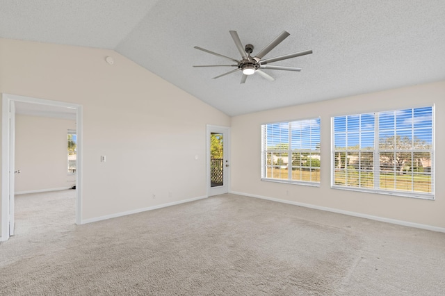 carpeted empty room with a textured ceiling, ceiling fan, and lofted ceiling