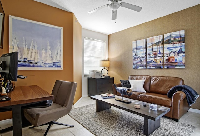 interior space featuring ceiling fan, light tile patterned flooring, and a textured ceiling