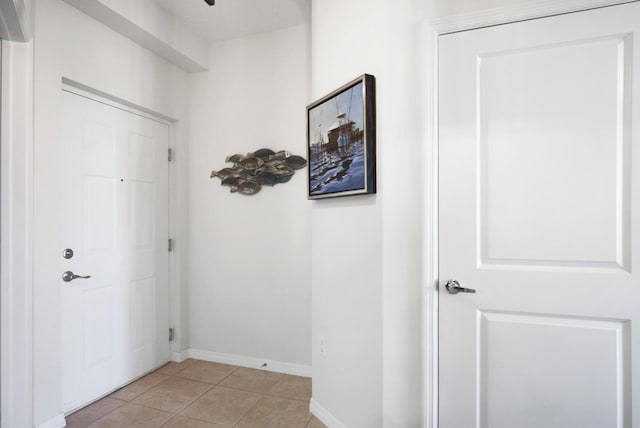 hall featuring light tile patterned flooring