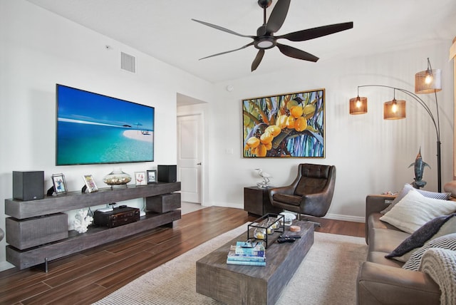 living room featuring wood-type flooring and ceiling fan